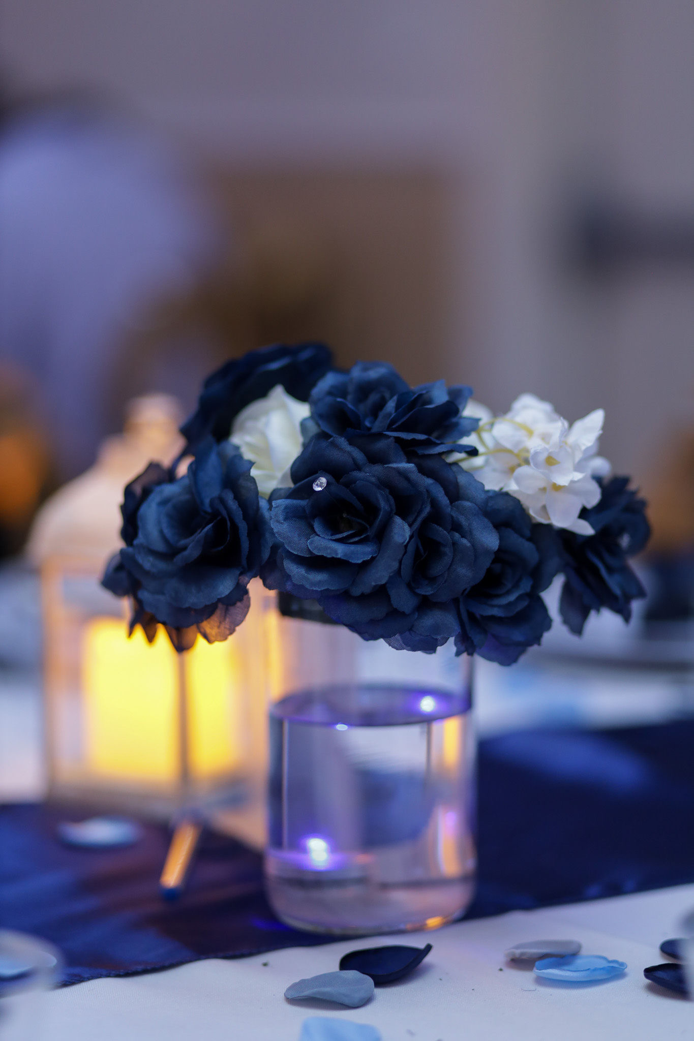 Entrance to a celebration with gold number balloons flanked by blue and gold balloon pillars.